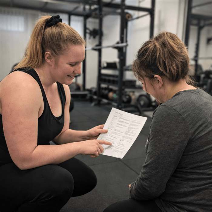 Katie guiding a client through her training program