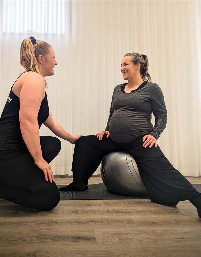 Katie coaching a pregnant client on a birth ball