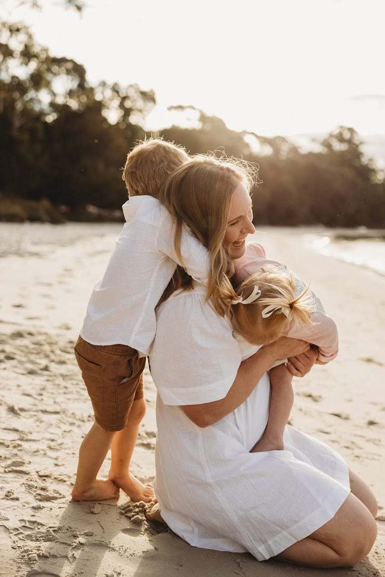 Katie on the beach with her two kids