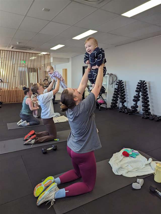 Mum squatting with toddler